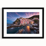 Black-framed wall art featuring a serene village landscape design. The piece showcases vibrant colors and intricate details, beautifully enhancing any home decor.