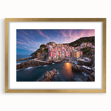 Framed wall art collection showcasing a scenic village landscape design in vibrant colors, with a stylish gold frame and white mat, perfect for home decor.
