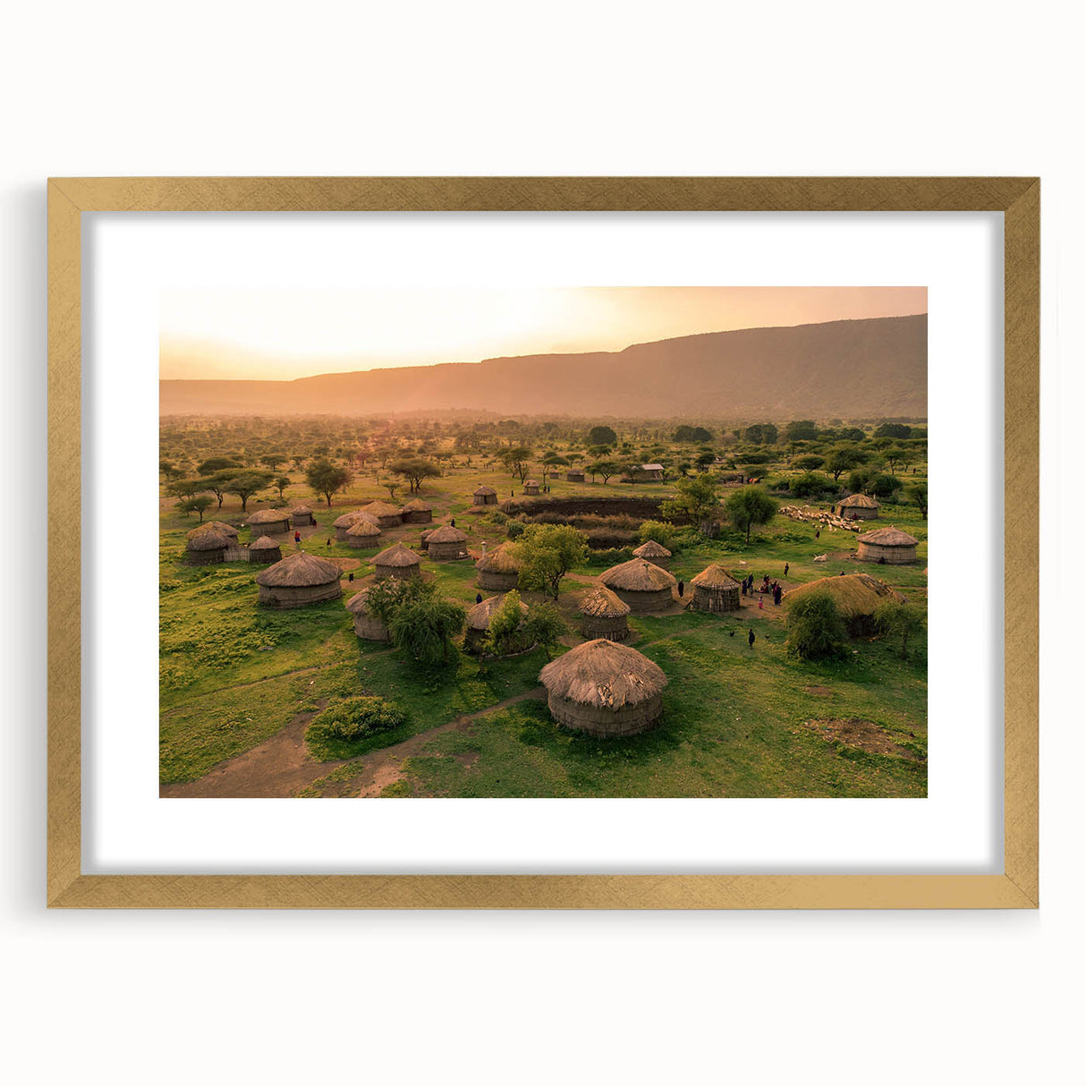 Framed wall art featuring a serene landscape village design with gold accents and a mat, showcasing intricate details and vibrant colors, ideal for home decor.