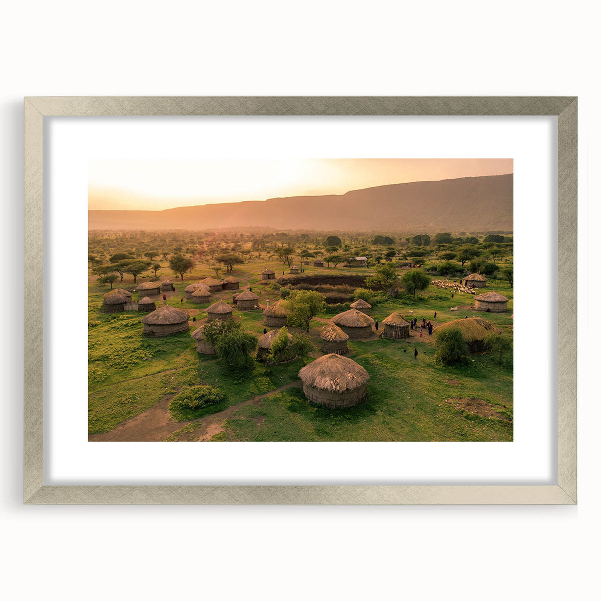Elegant silver-framed wall art showcasing a picturesque village landscape design, complete with a white mat for added depth, perfect for home decor enhancement.