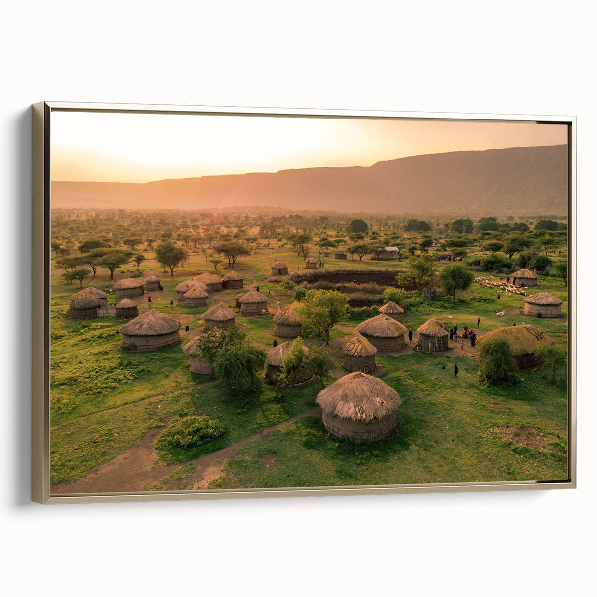 Framed canvas wall art showcasing a serene village landscape in soft pastel colors with a gold frame, ideal for enhancing home decor and creating a tranquil ambiance.