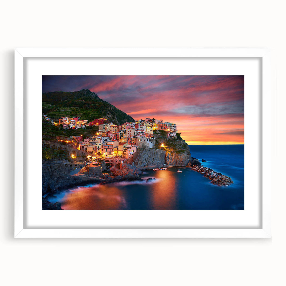 Framed white wall art showcasing a picturesque village landscape design, featuring vibrant colors and intricate details, perfect for home decor enhancements.