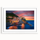 Framed white wall art showcasing a picturesque village landscape design, featuring vibrant colors and intricate details, perfect for home decor enhancements.