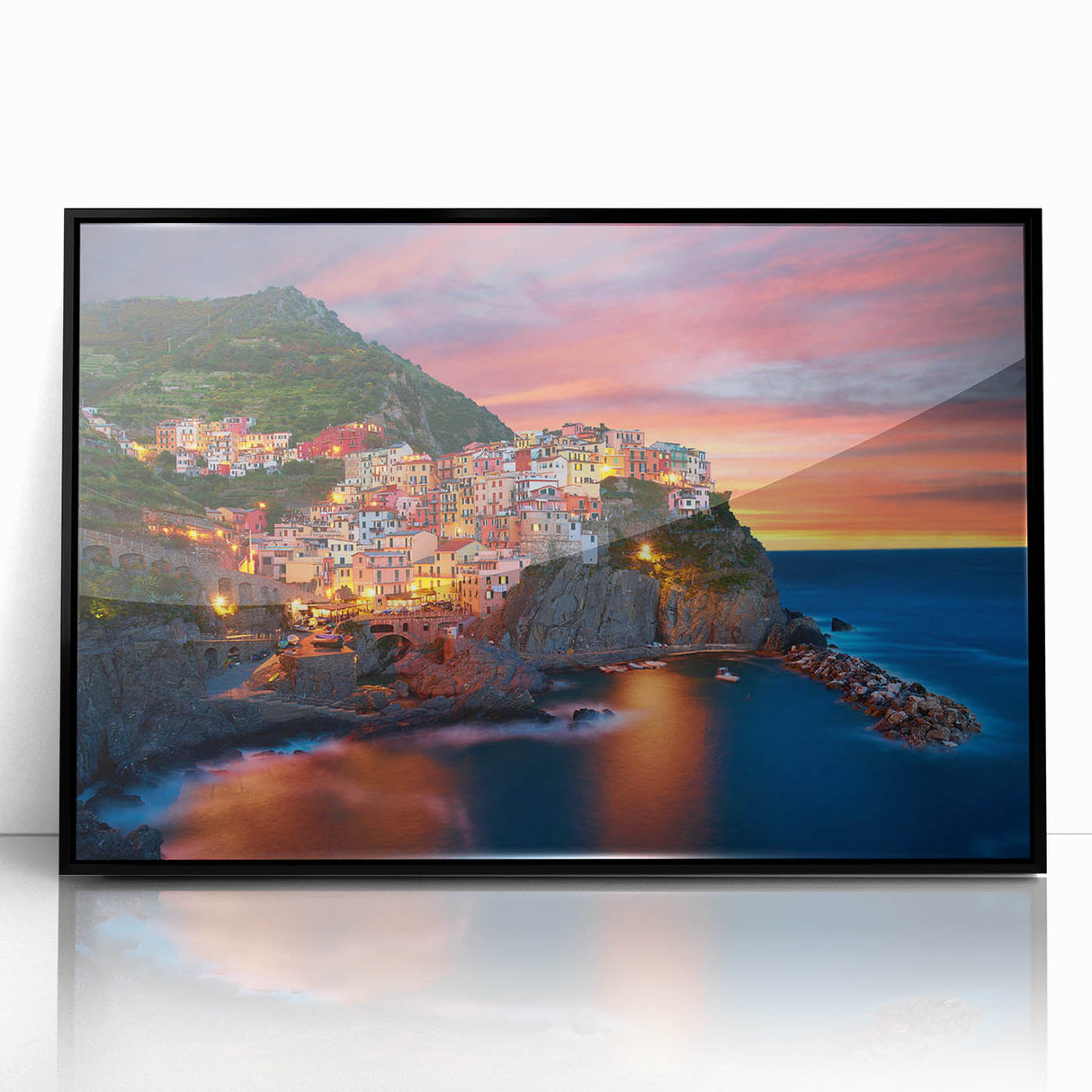 Framed acrylic wall art featuring a vibrant landscape of a village scene, showcasing colorful homes and lush greenery, with a sleek black frame enhancing its modern aesthetic. Perfect for adding a touch of nature-inspired decor to any living space.