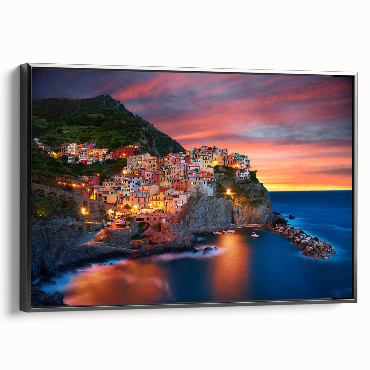 Framed canvas wall art showcasing a vibrant village landscape design, featuring rich colors and intricate details, with a sleek black frame enhancing its elegance.