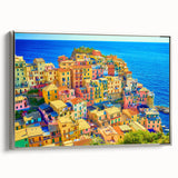 Framed canvas wall art showcasing a serene village landscape with mountains, presented in a sleek silver frame, perfect for enhancing home decor.