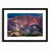 Black-framed wall art featuring a serene village landscape design, complete with a white mat, ideal for enhancing home decor with a touch of nature.