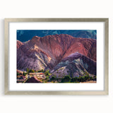 Framed wall art featuring a serene landscape of a quaint village, accented with a silver mat and frame, ideal for home decor and interior design enhancement.