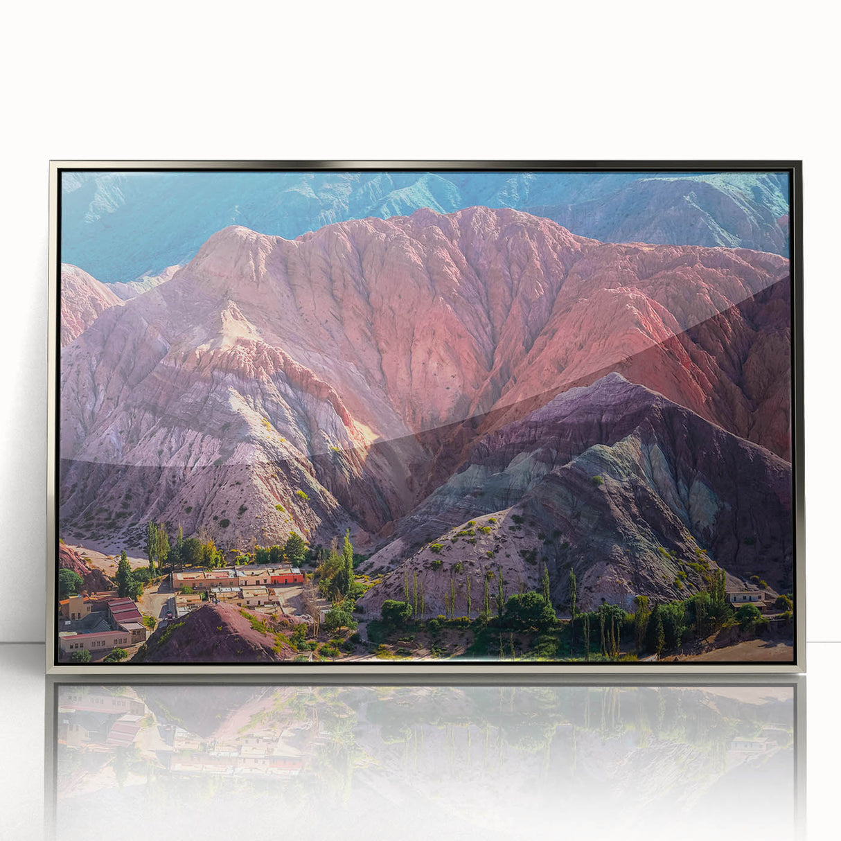 Framed wall art featuring a serene village landscape design in silver acrylic. The artwork showcases vibrant colors and intricate details, perfect for home decor.