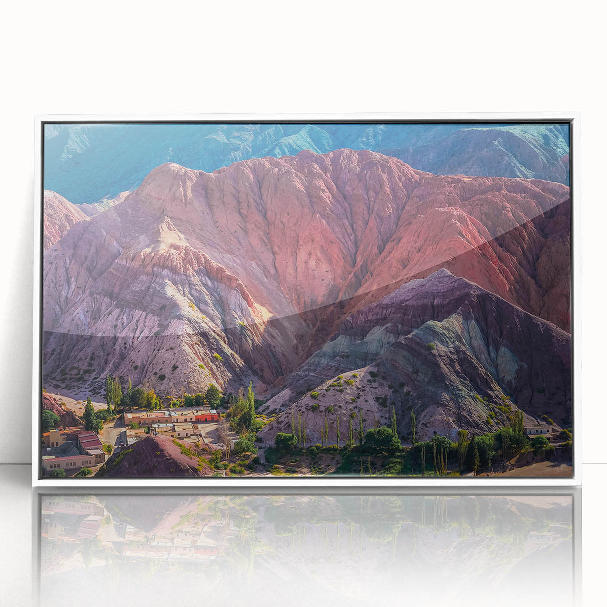 Framed wall art collection showcasing a serene village landscape design with vibrant colors and intricate details, displayed in a sleek white frame for modern decor.