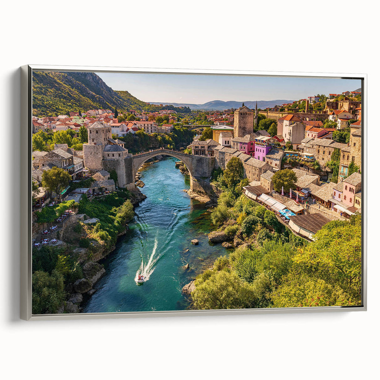Framed canvas wall art depicting a serene village landscape with soft color tones, featuring silver accents and a modern design, ideal for home decor.