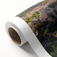 Rolled canvas artwork showcasing a vibrant village landscape design, featuring colorful houses and lush greenery, perfect for home decor. Packaged securely in a cardboard tube.