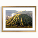 Framed wall art depicting a vibrant volcano landscape with rich colors and intricate details, featuring a gold mat and frame, ideal for home decor.