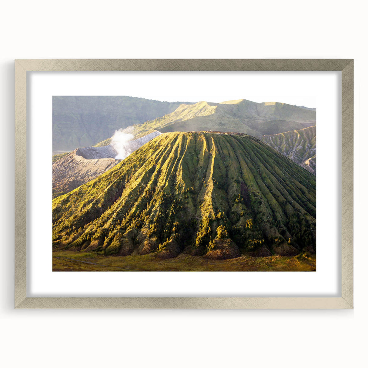 Framed wall art featuring a stunning landscape design of a volcano, showcased in a sleek silver frame with a mat, perfect for home decor enthusiasts.
