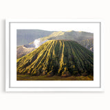 Framed wall art depicting a vibrant volcanic landscape, featuring bold colors and intricate details, showcased in a sleek white mat and frame, ideal for home decor.