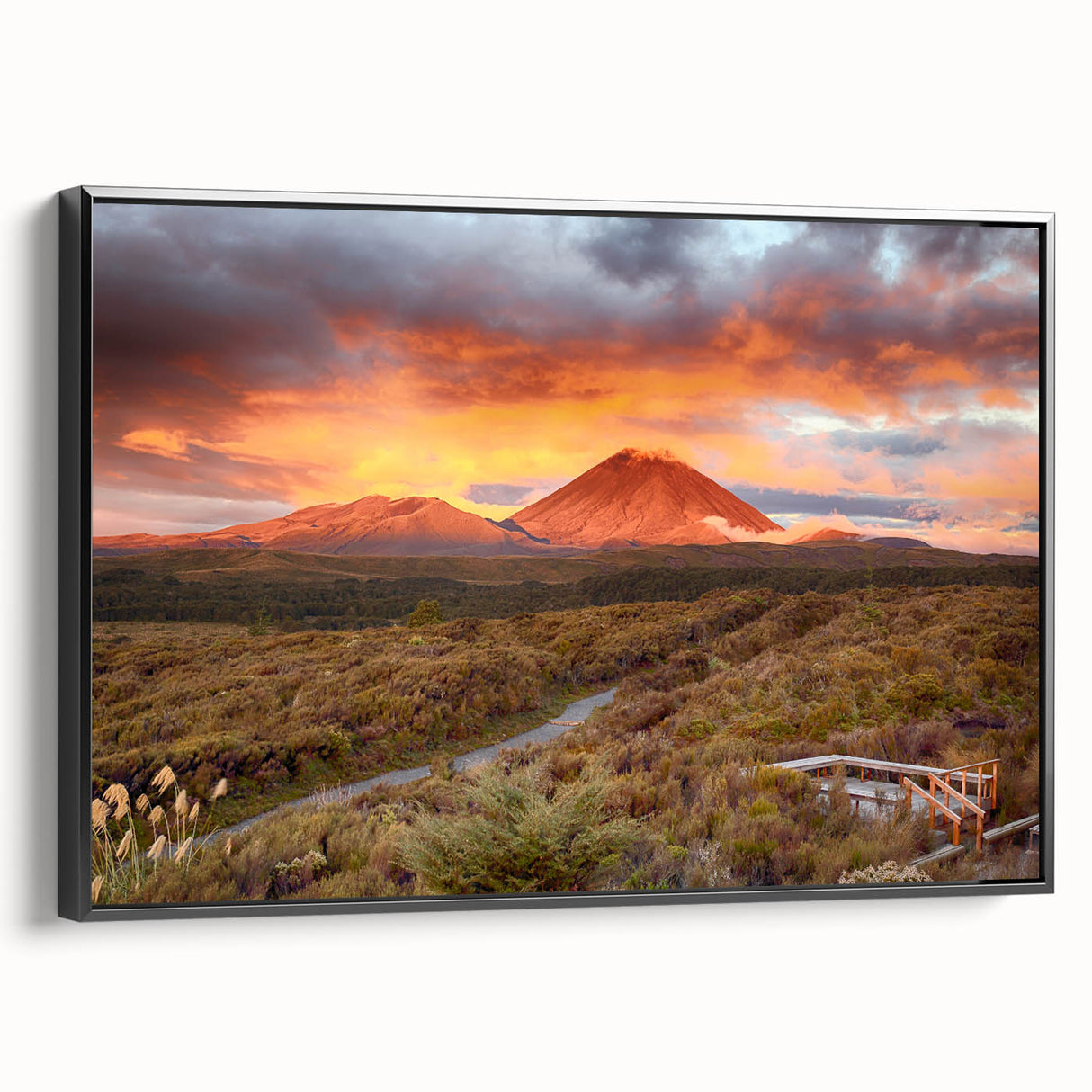 Framed canvas wall art showcasing a vibrant volcano landscape design with bold colors, set against a black frame, ideal for home decor enthusiasts.