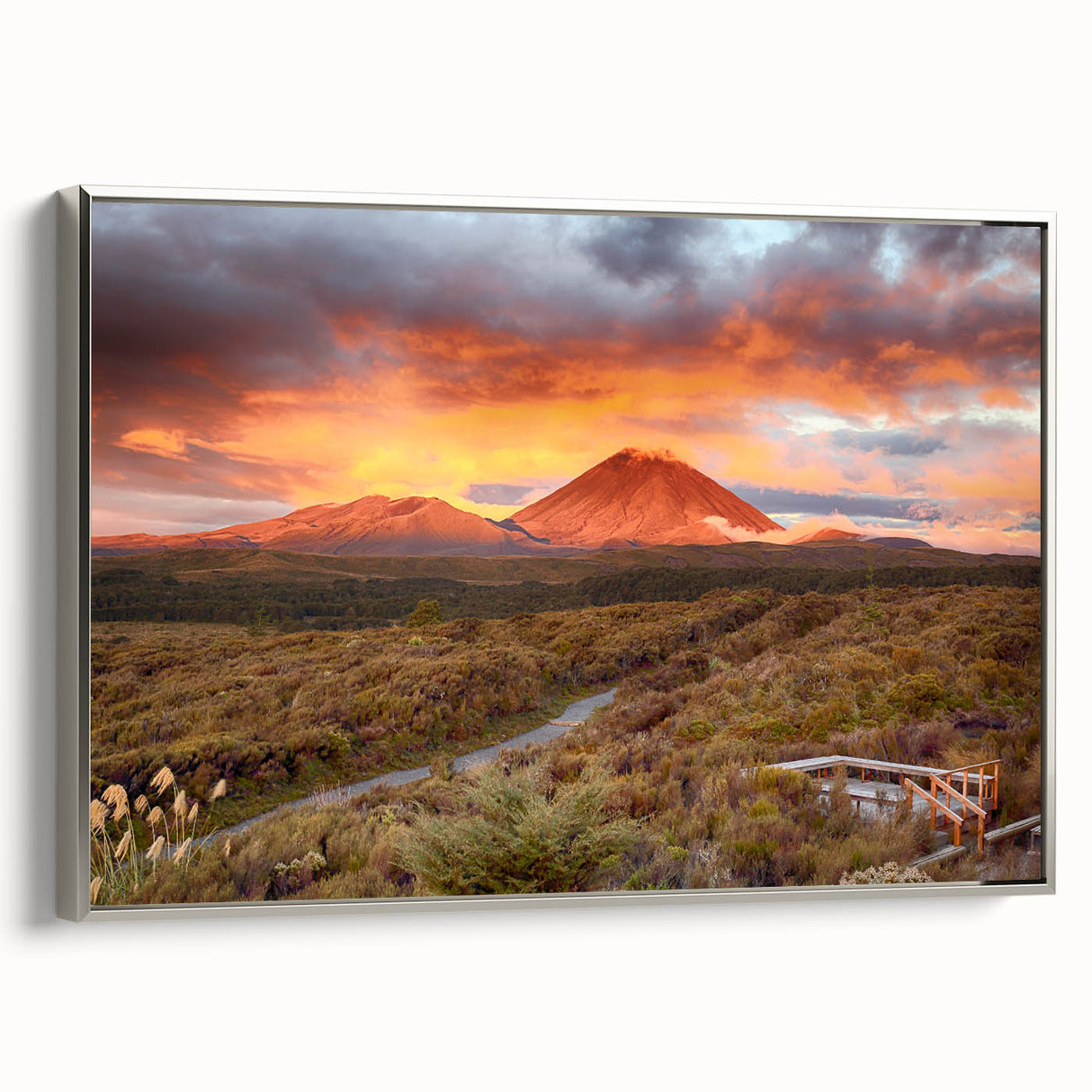 Framed canvas wall art depicting a vibrant volcanic landscape with dramatic colors and intricate details, set against a sleek silver frame for modern decor.
