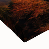 Close-up of vibrant stretched canvas wall art depicting an erupting volcano, showcasing rich orange and red lava against a dark background, perfect for home decor.