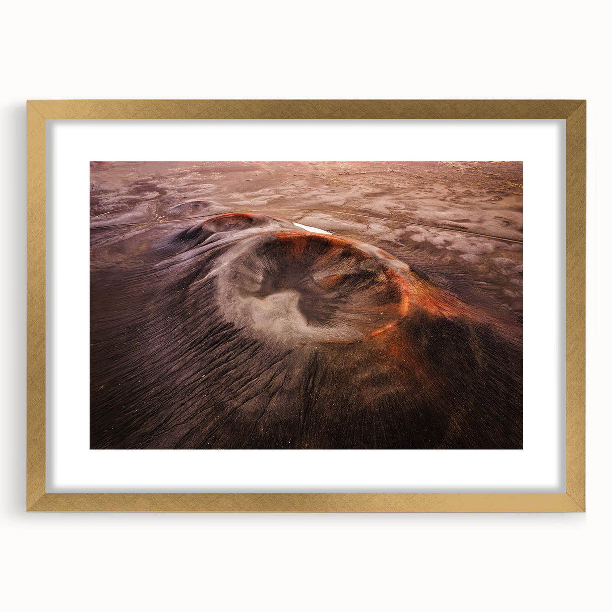 Framed wall art featuring a stunning volcanic landscape design with a gold mat. The piece showcases vibrant colors and intricate details, ideal for home decor.