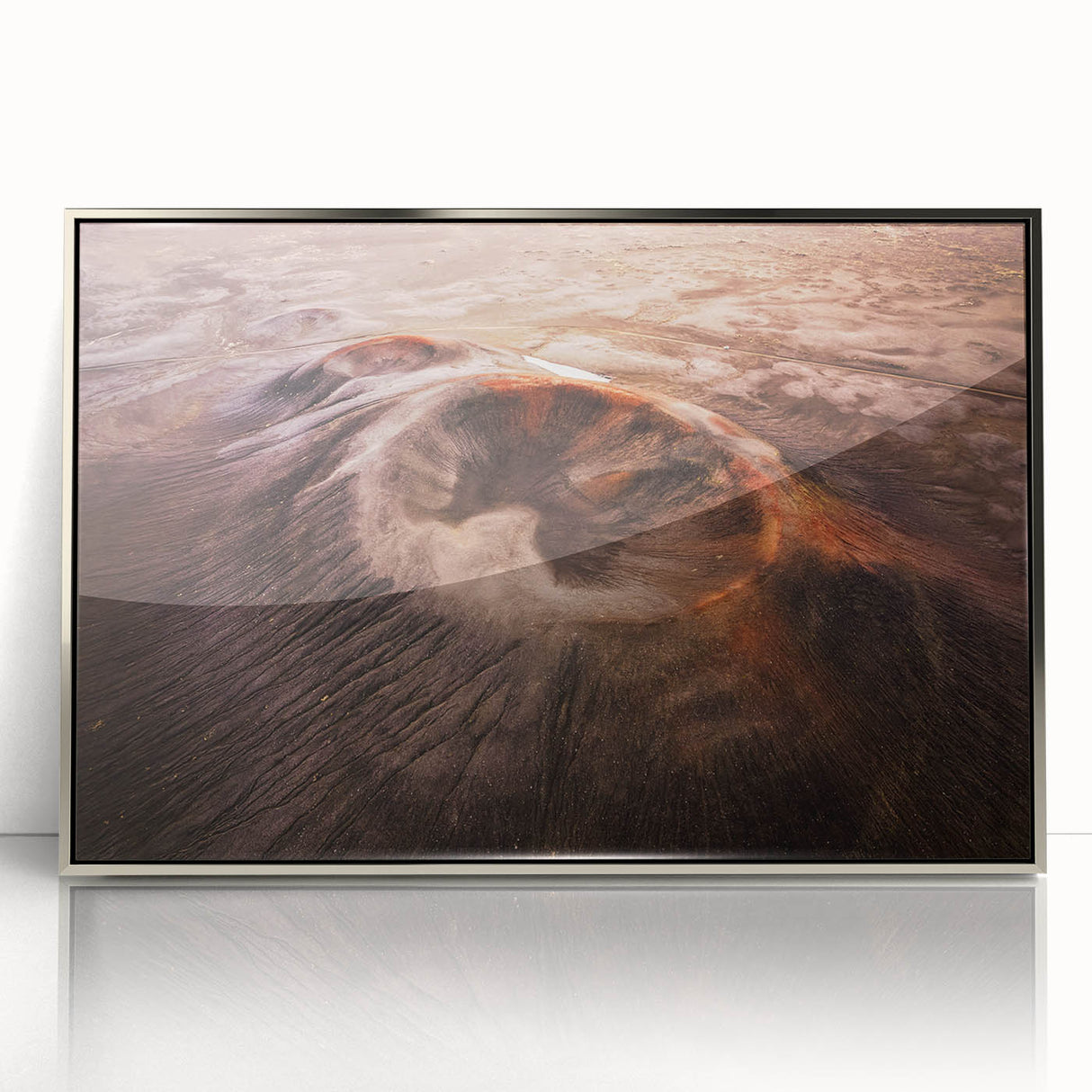 Framed acrylic wall art featuring a vibrant landscape design of a volcano, elegantly set in a sleek silver frame, ideal for modern decor.