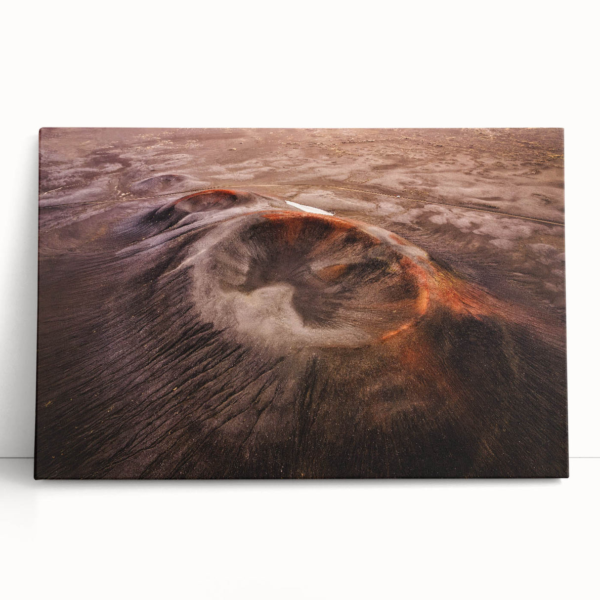 Stretched canvas wall art showcasing a vibrant landscape design with an erupting volcano, set against a dramatic sunset sky. Perfect for home decor enthusiasts.