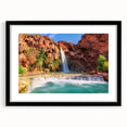 Framed black wall art showcasing a serene waterfall landscape, featuring vibrant blue water and lush green foliage, perfect for home decor enhancement.