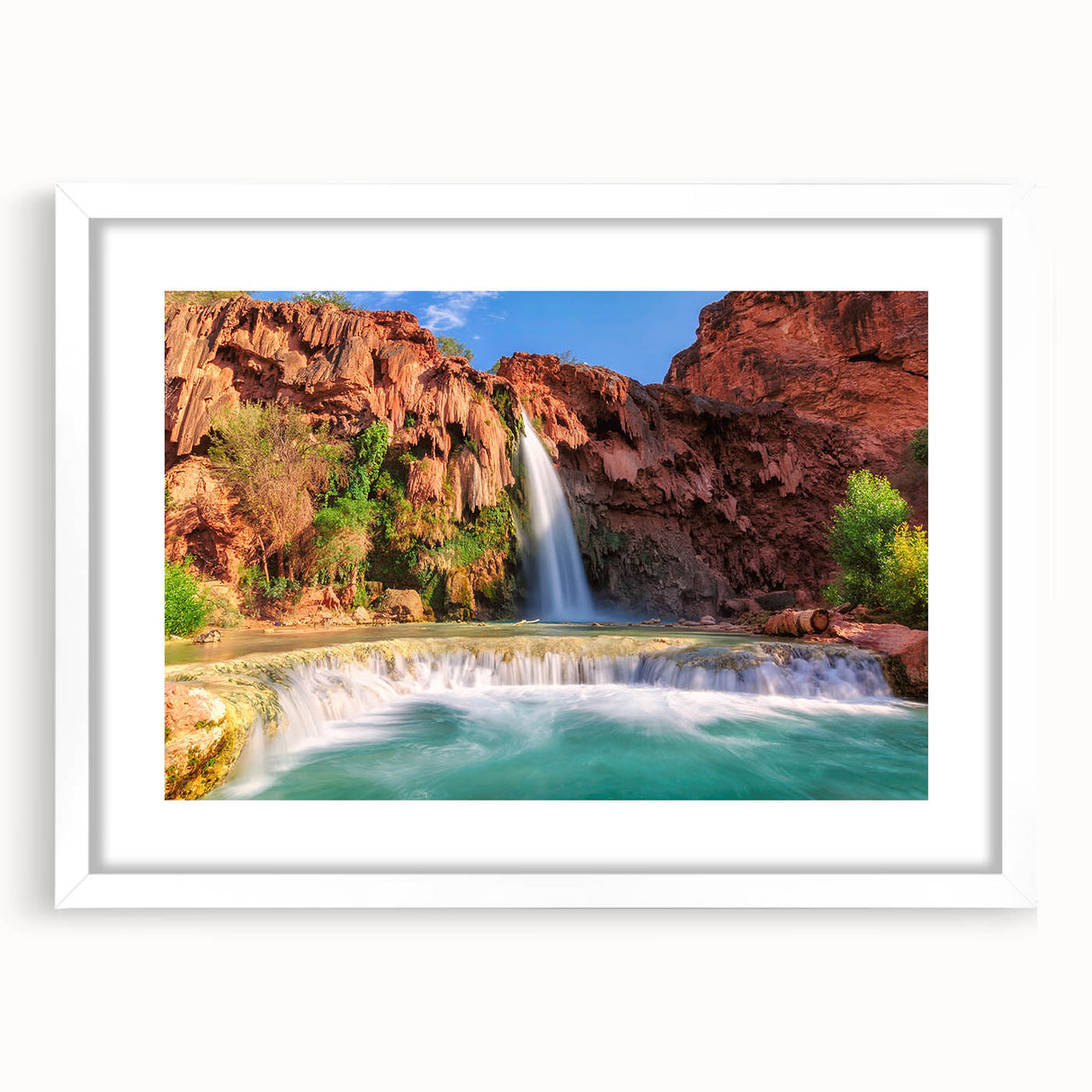 Framed wall art featuring a serene landscape of cascading waterfalls, set in a white mat and frame, perfect for enhancing home decor with nature-inspired elegance.