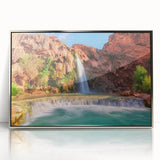Framed acrylic wall art depicting a serene waterfall landscape, showcasing vibrant blues and greens, perfect for enhancing home decor with a tranquil vibe.