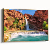 Framed canvas wall art showcasing a serene waterfall landscape with vibrant greens and blues, accented by a stylish gold frame, ideal for home decor.
