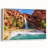 Framed canvas wall art showcasing a serene waterfall landscape design, featuring vibrant blue and green hues, set against a white frame, ideal for home decor.