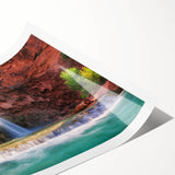 Vibrant landscape wall art print showcasing a serene waterfall cascading over rocks, surrounded by lush greenery, perfect for home decor or office spaces.