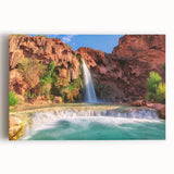 Stretched canvas wall art showcasing a vibrant waterfall landscape with lush greenery and blue skies, perfect for enhancing any home decor. Ideal for nature lovers.