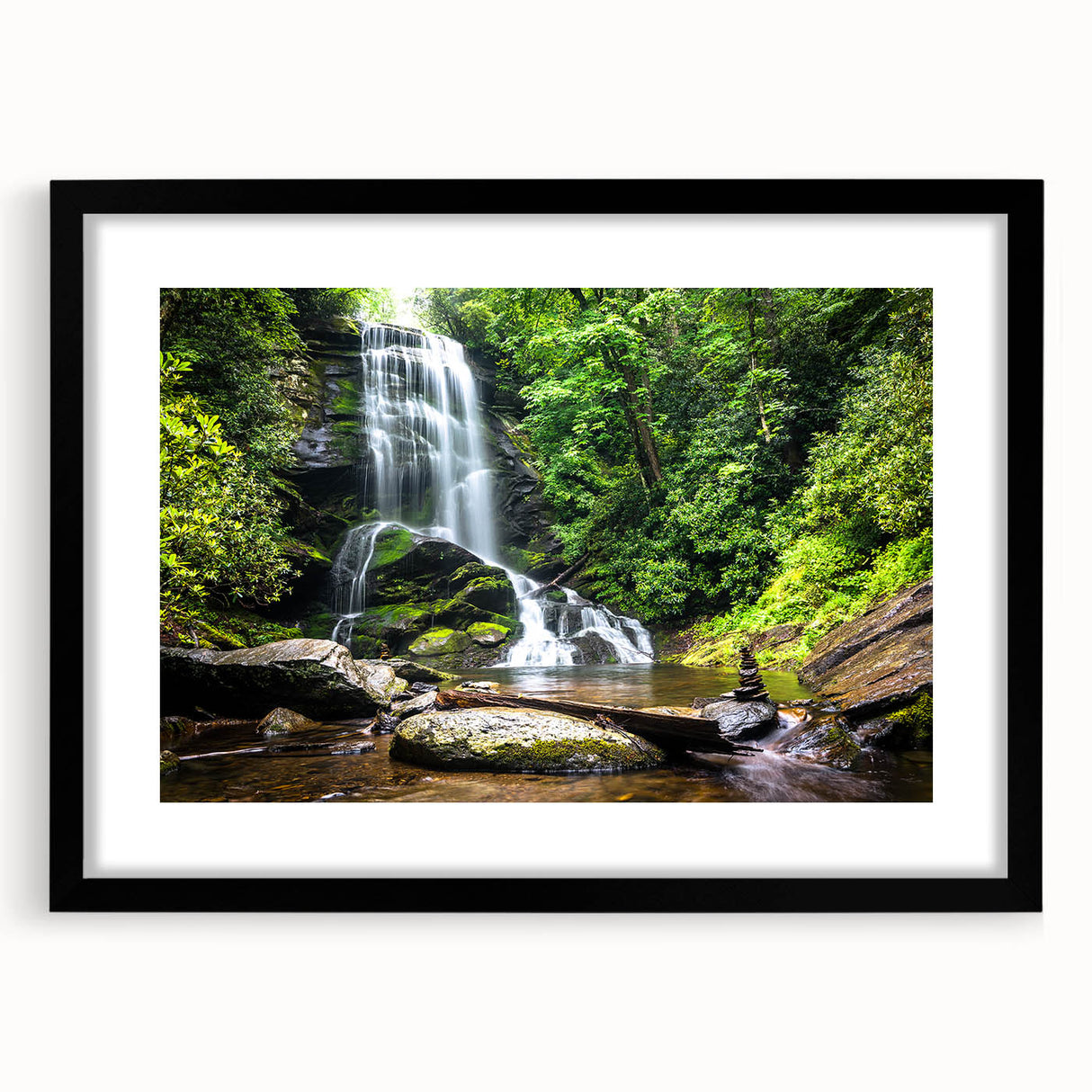 Framed wall art depicting a serene waterfall landscape design, featuring vibrant blues and greens, set in a sleek black frame with a white mat, perfect for home decor.