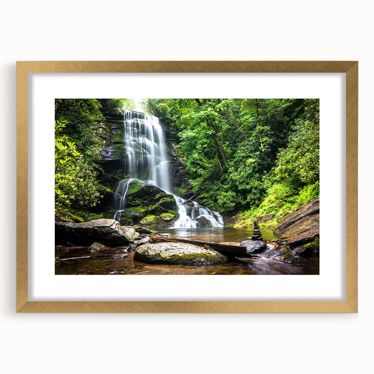 Framed wall art showcasing a serene waterfall landscape in vibrant colors, complete with a gold mat, perfect for enhancing home decor. The design brings a calming nature element into living spaces.