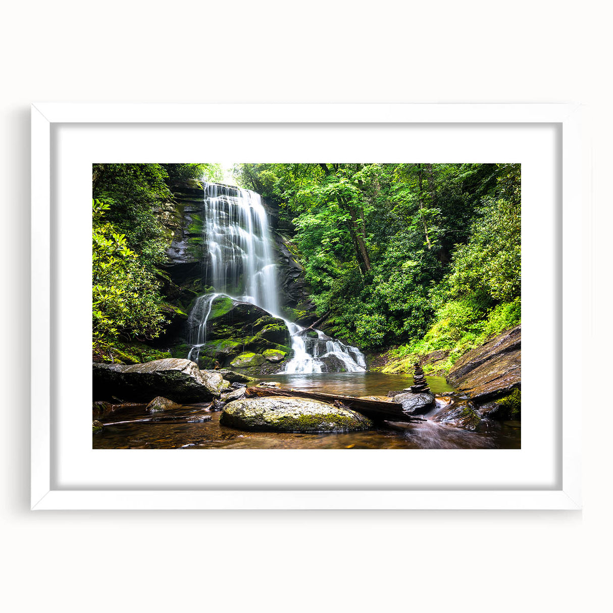Framed landscape wall art showcasing a serene waterfall scene, accented by a white mat and sleek frame, perfect for home decor and nature lovers.