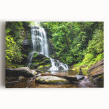 Stretched canvas wall art showcasing a vibrant landscape of cascading waterfalls, surrounded by lush greenery, perfect for nature-themed decor in living spaces.
