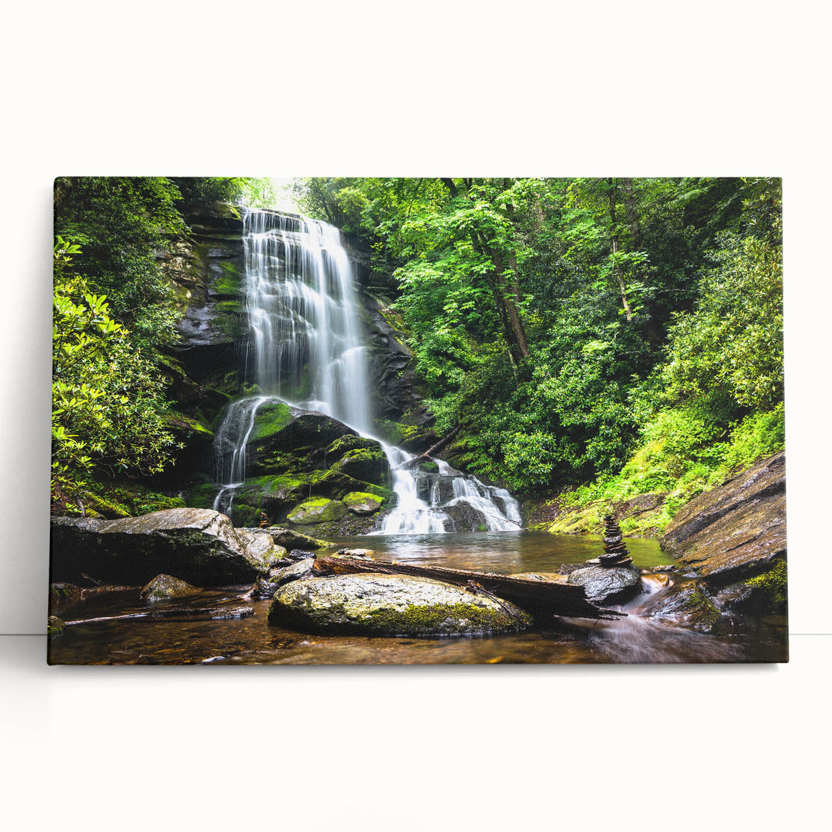 Stretched canvas wall art depicting a vibrant waterfall landscape with lush greenery and cascading water, ideal for home decor, showcasing nature's beauty.