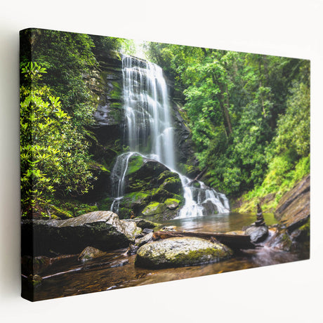 Stretched canvas wall art depicting a serene waterfall landscape with vibrant blue and green hues, ideal for enhancing home decor and creating a calming atmosphere.