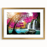 Framed wall art showcasing a serene waterfall landscape, featuring vibrant greens and calming blues, with a gold mat and frame for an elegant touch. Ideal for enhancing home decor and creating a tranquil atmosphere.
