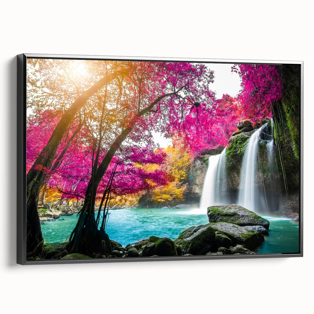 Framed wall art featuring a stunning landscape with cascading waterfalls, set against a vibrant natural backdrop. The canvas is elegantly framed in black, enhancing the overall aesthetic appeal and making it a perfect decorative piece for home or office environments.