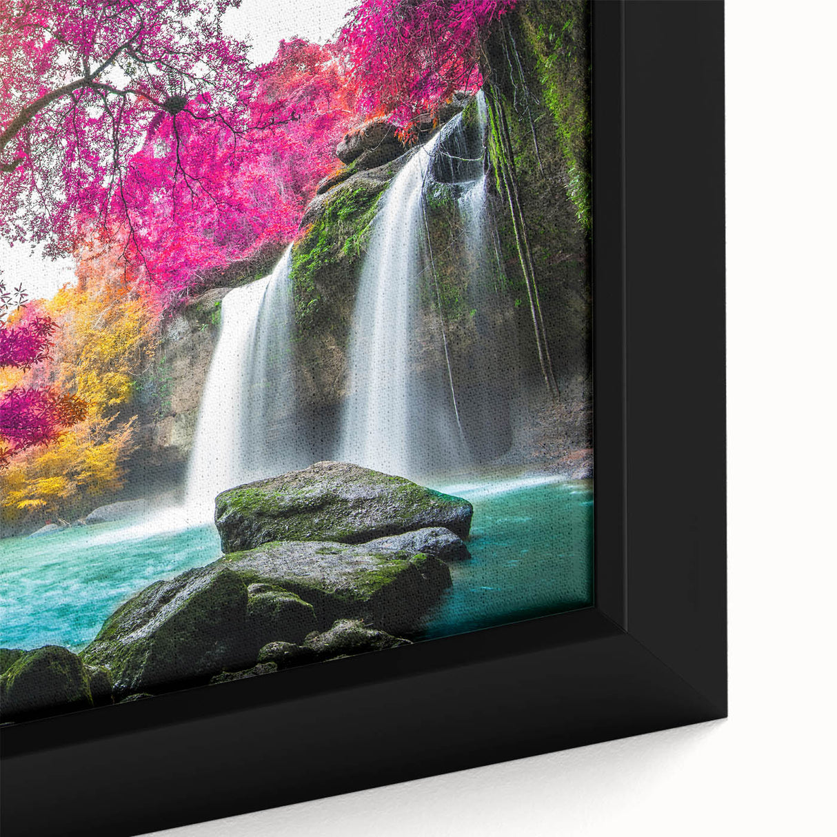 Framed canvas artwork showcasing a vibrant waterfall landscape, with lush greenery and a serene blue sky, perfect for enhancing home decor. The close-up reveals intricate details and textures, making it an ideal centerpiece for nature enthusiasts.