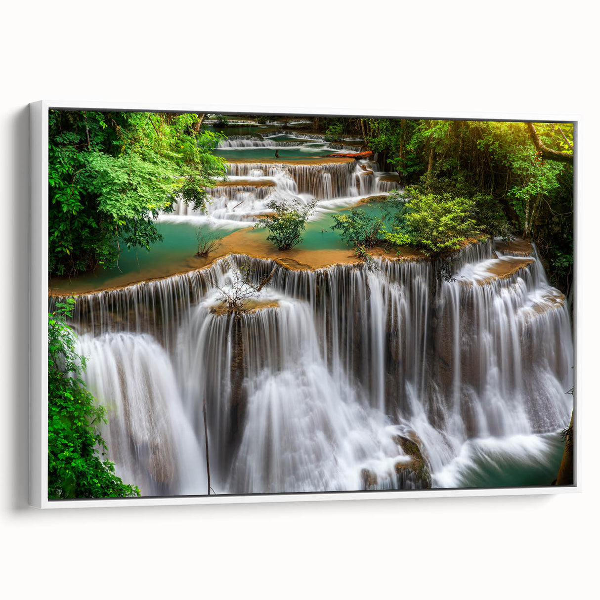 Framed canvas artwork showcasing a serene waterfall landscape in vibrant colors, designed for wall decor, with a white frame adding elegance to any room.
