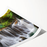 Vibrant rolled print showcasing a stunning waterfall landscape, perfect for home decor, featuring rich blues and greens, elegantly packaged in a protective tube.