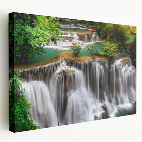 Stretched canvas wall art showcasing a stunning waterfall landscape in vibrant blues and greens, designed for home decor, enhancing any room's aesthetic. The artwork captures the serene beauty of nature, inviting tranquility into the space.