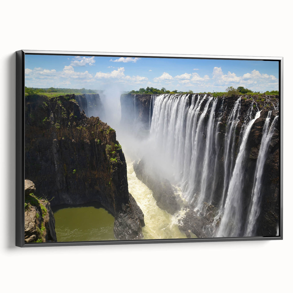 Framed canvas wall art depicting a serene waterfall landscape, showcasing vibrant blues and greens, with a sleek black frame enhancing its modern aesthetic. Ideal for nature lovers and home decor enthusiasts.