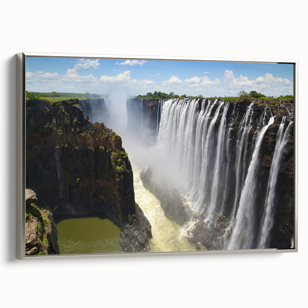 Framed canvas wall art showcasing a serene waterfall landscape with lush greenery and a silver frame, ideal for modern home decor and nature enthusiasts.