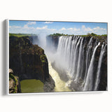 Framed canvas wall art depicting a stunning waterfall landscape, featuring vibrant greens and blues, set against a white frame for a modern look, ideal for home decor.