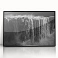 Framed wall art showcasing a serene waterfall landscape design, featuring vibrant blues and greens, encased in a sleek black frame, perfect for home decor.