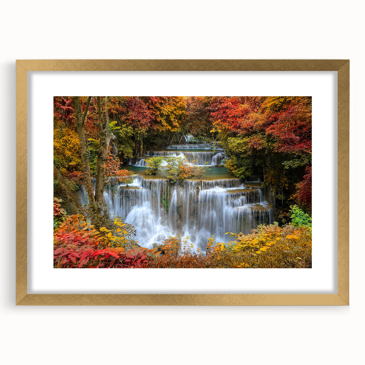 Elegant gold-framed wall art showcasing a serene waterfall landscape, complete with a white mat for added contrast, perfect for enhancing home decor.
