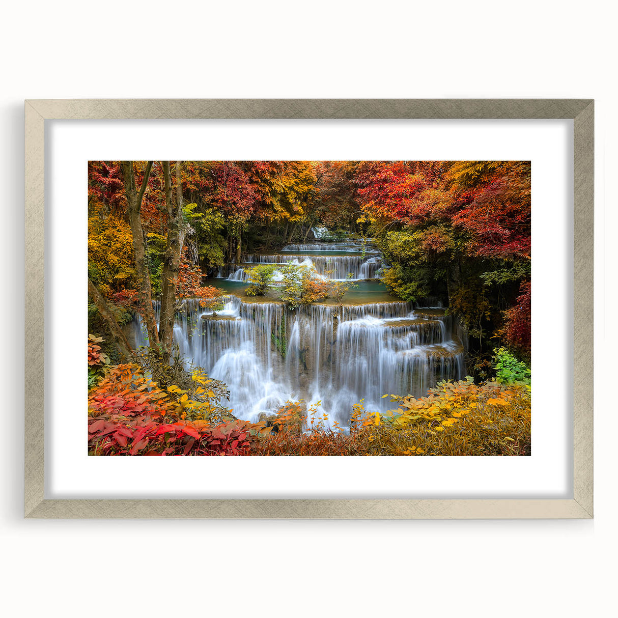 Framed wall art featuring a serene waterfall landscape in vibrant colors, set within a sleek silver frame with a mat border, ideal for home decor enhancement.